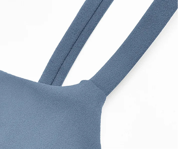 Close-up of a blue bra with thin straps on a white background